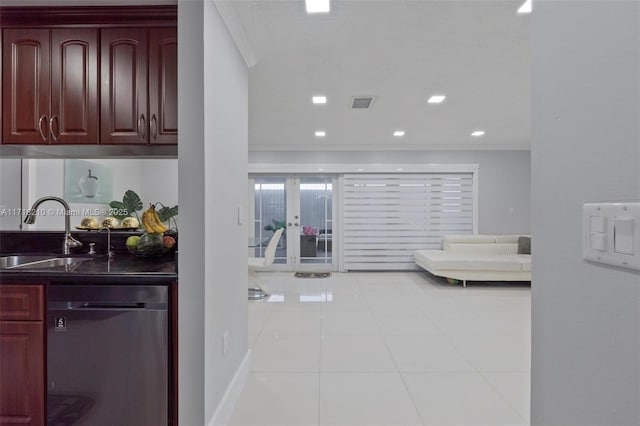 interior space featuring dishwasher, light tile patterned floors, ornamental molding, and sink