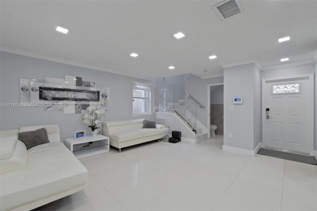 living room with light tile patterned floors and crown molding