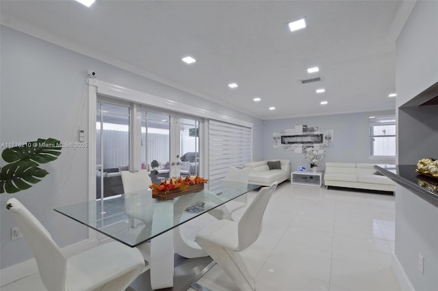 tiled dining space featuring french doors and ornamental molding