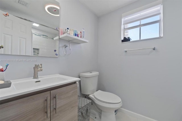 bathroom featuring vanity and toilet