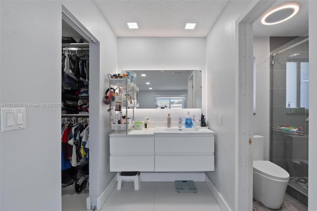 bathroom featuring tile patterned floors, vanity, a textured ceiling, toilet, and a shower with shower door