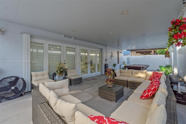 view of patio / terrace featuring outdoor lounge area, french doors, and a hot tub