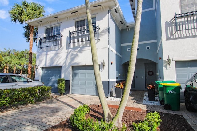 view of front of house featuring a balcony and a garage