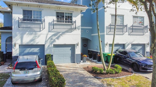 view of front facade featuring a balcony and a garage