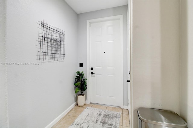 doorway with light tile patterned flooring