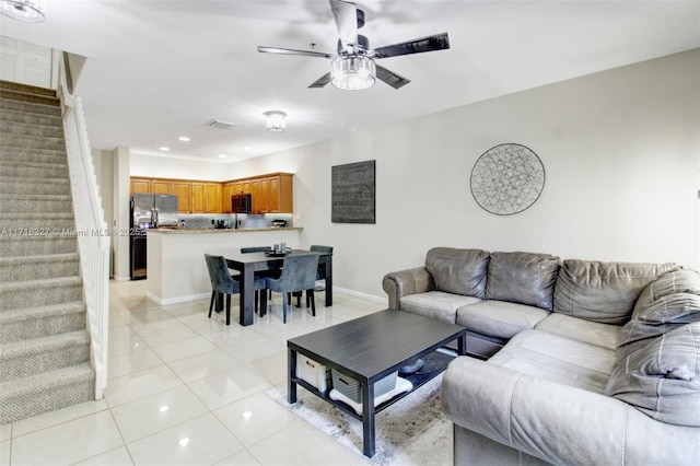 tiled living room with ceiling fan