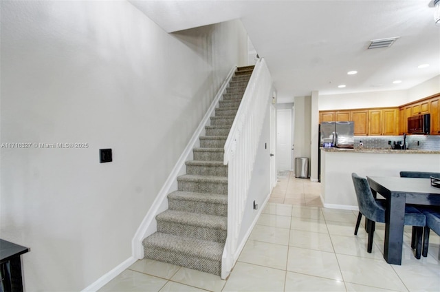 stairway with tile patterned flooring