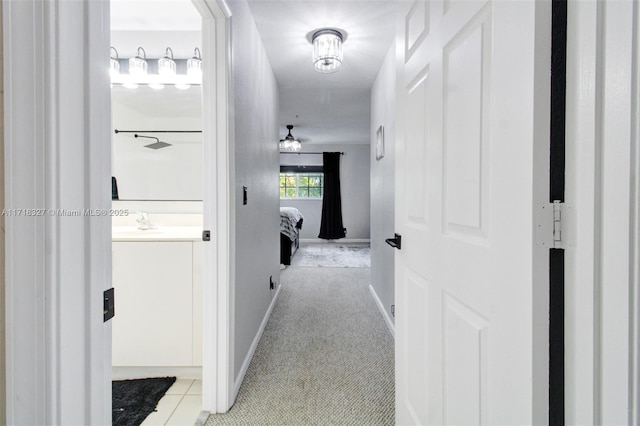 corridor with light tile patterned floors and sink