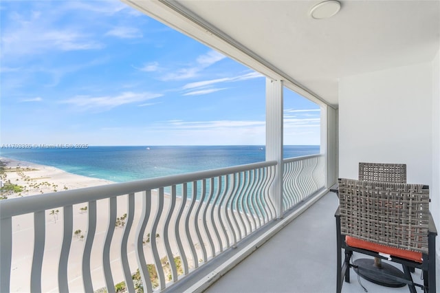 balcony featuring a water view and a beach view