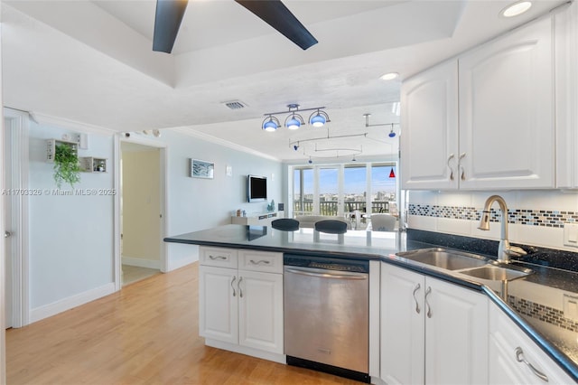 kitchen with stainless steel dishwasher, crown molding, sink, white cabinets, and light hardwood / wood-style floors