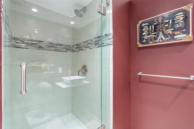 bathroom featuring a shower with shower door