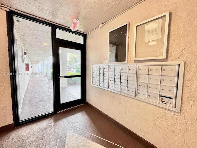 doorway to outside with carpet, mail boxes, and a textured ceiling