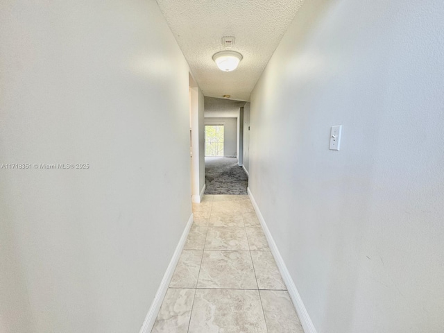 corridor with a textured ceiling