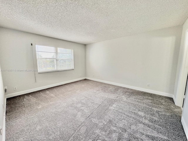 carpeted spare room featuring a textured ceiling