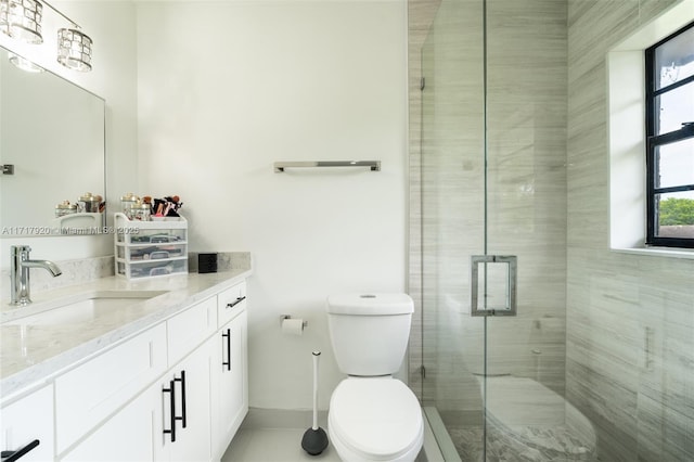 bathroom with vanity, a shower with shower door, and toilet