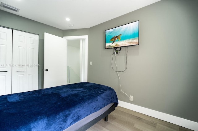 bedroom featuring light hardwood / wood-style flooring and a closet