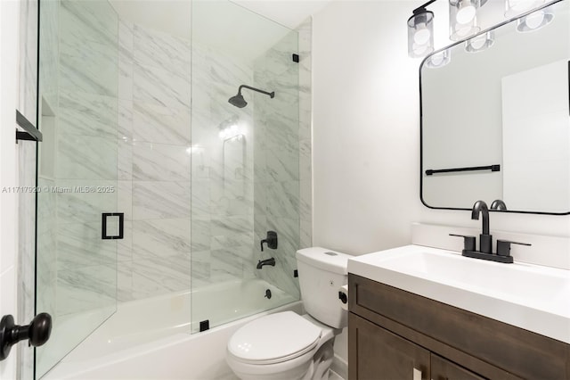 full bathroom featuring combined bath / shower with glass door, vanity, and toilet