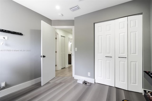 bedroom featuring a closet and light hardwood / wood-style floors