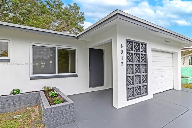 doorway to property with a garage