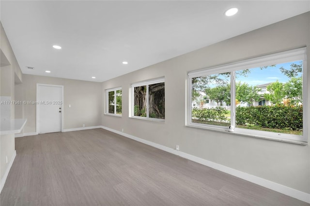 unfurnished room with light wood-type flooring