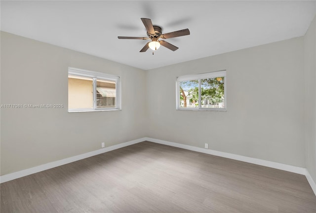 empty room featuring ceiling fan and hardwood / wood-style flooring