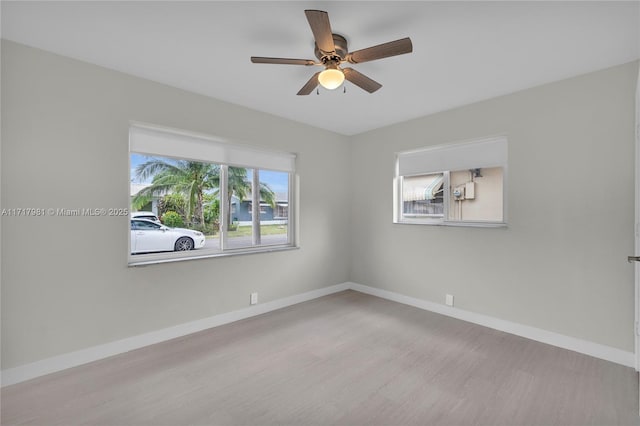 empty room with ceiling fan and light wood-type flooring