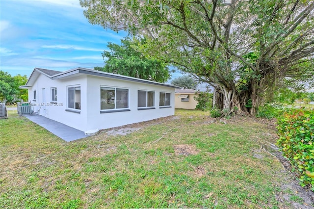 view of property exterior featuring cooling unit and a lawn