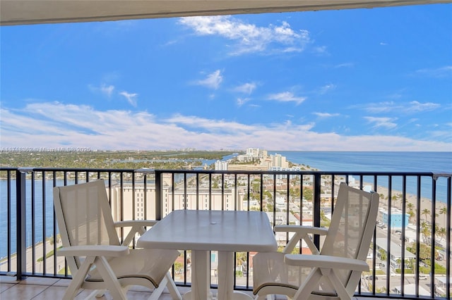 balcony featuring a water view and a view of the beach