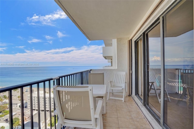 balcony featuring a water view and a view of the beach