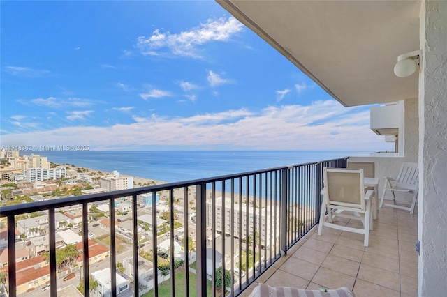 balcony featuring a water view and a beach view