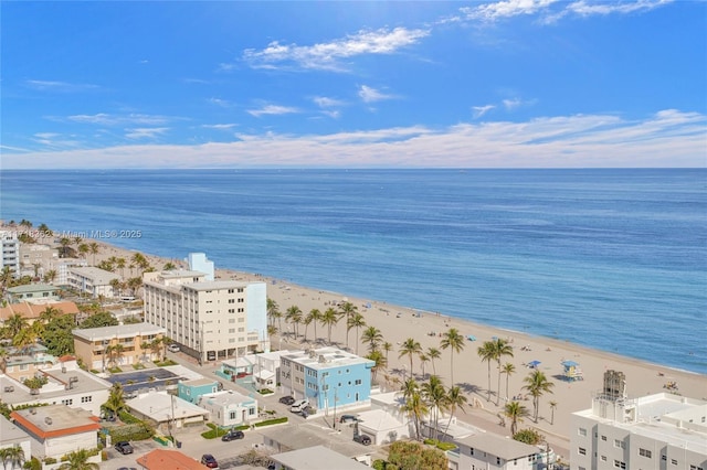 drone / aerial view featuring a beach view and a water view