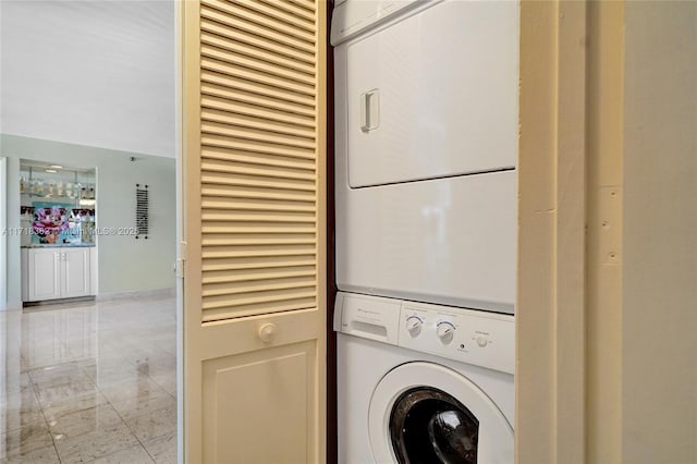 laundry area with stacked washer and dryer