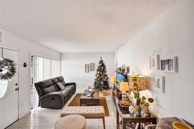 living room with light tile patterned floors and a textured ceiling