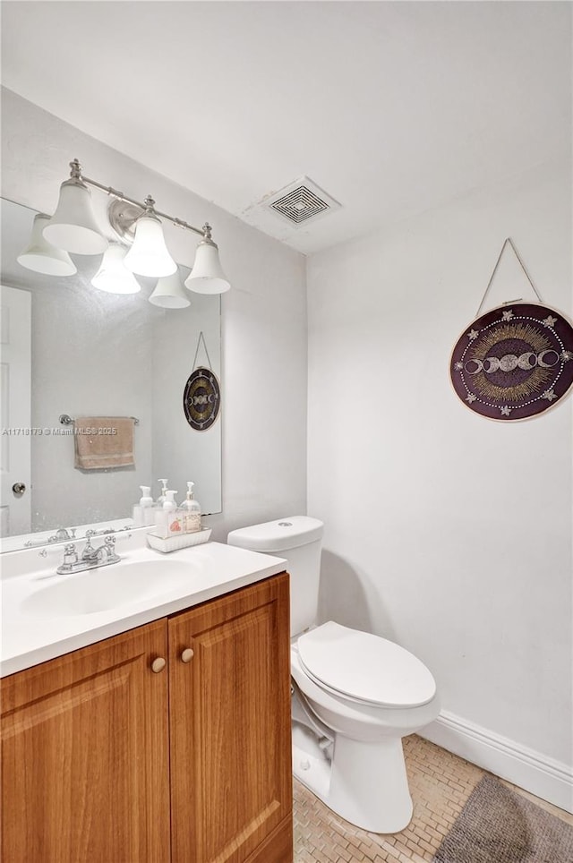 bathroom with tile patterned floors, vanity, and toilet