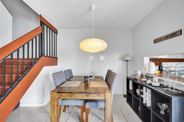 dining area with light tile patterned flooring and a textured ceiling