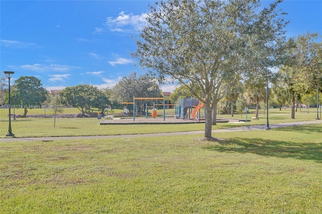 surrounding community with a yard and a playground