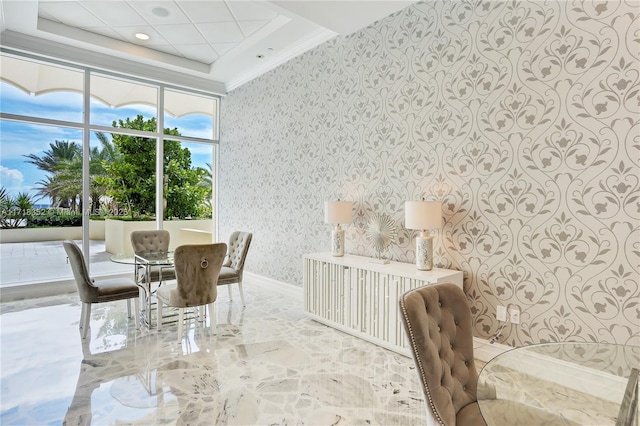 dining area with crown molding and a tray ceiling