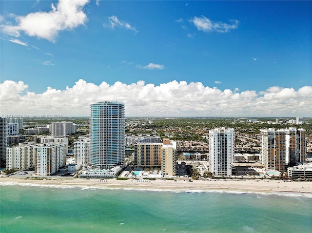 birds eye view of property with a water view and a view of the beach