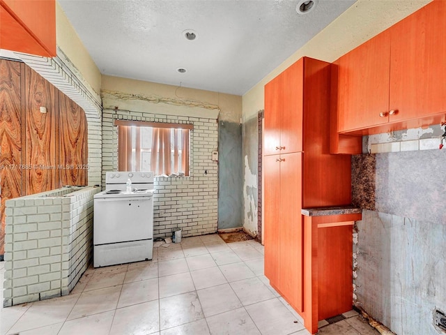 kitchen with a textured ceiling and white electric stove