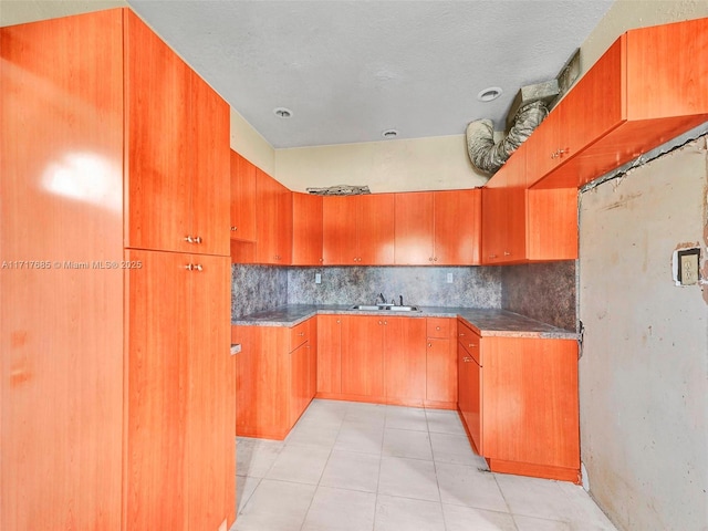 kitchen with light tile patterned floors and sink