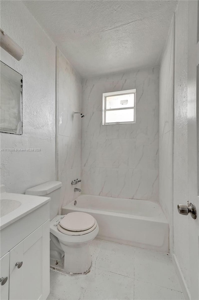 full bathroom with vanity, toilet, a textured ceiling, and tiled shower / bath