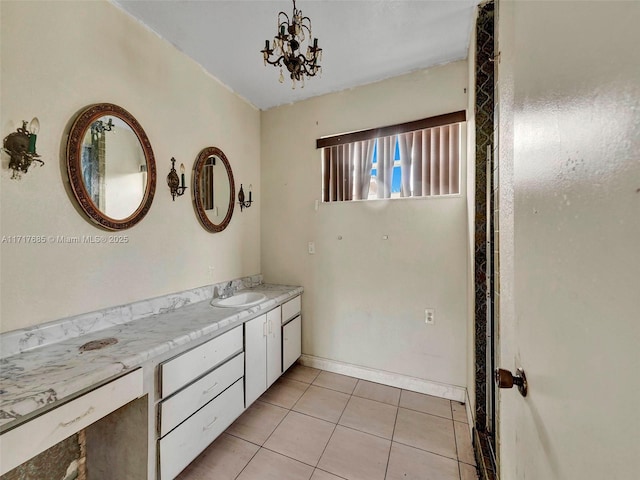 bathroom featuring tile patterned flooring, vanity, and an inviting chandelier