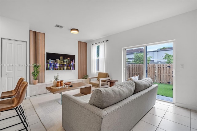 living room featuring visible vents and light tile patterned floors