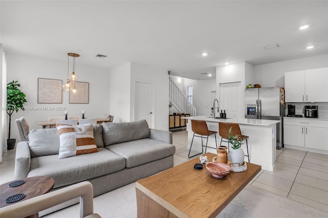 living room with recessed lighting, visible vents, and light tile patterned floors