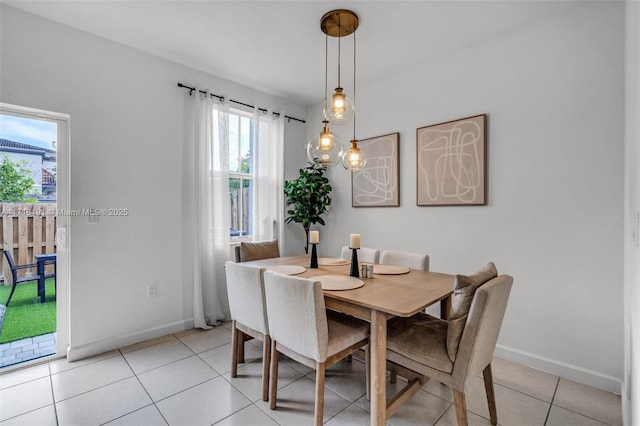 dining area with light tile patterned floors and baseboards