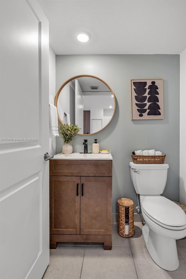 bathroom featuring tile patterned flooring, visible vents, vanity, and toilet