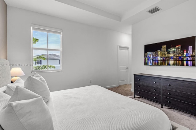 carpeted bedroom with visible vents and baseboards