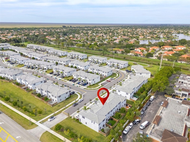 bird's eye view with a water view and a residential view