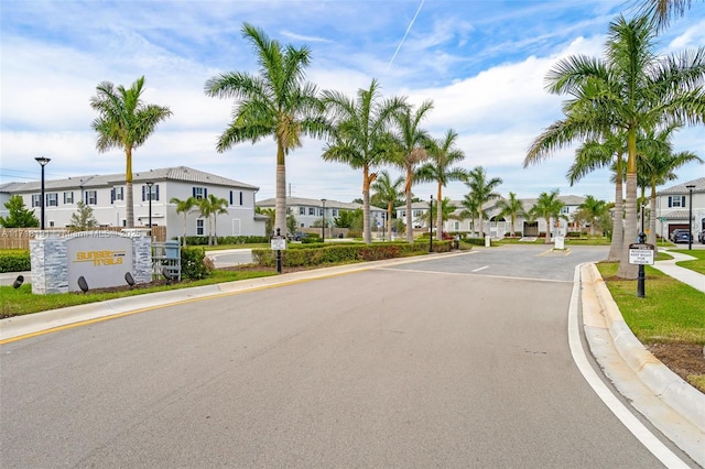 view of street featuring street lighting, a residential view, and curbs