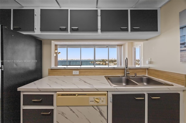 kitchen featuring dishwasher, refrigerator, and sink